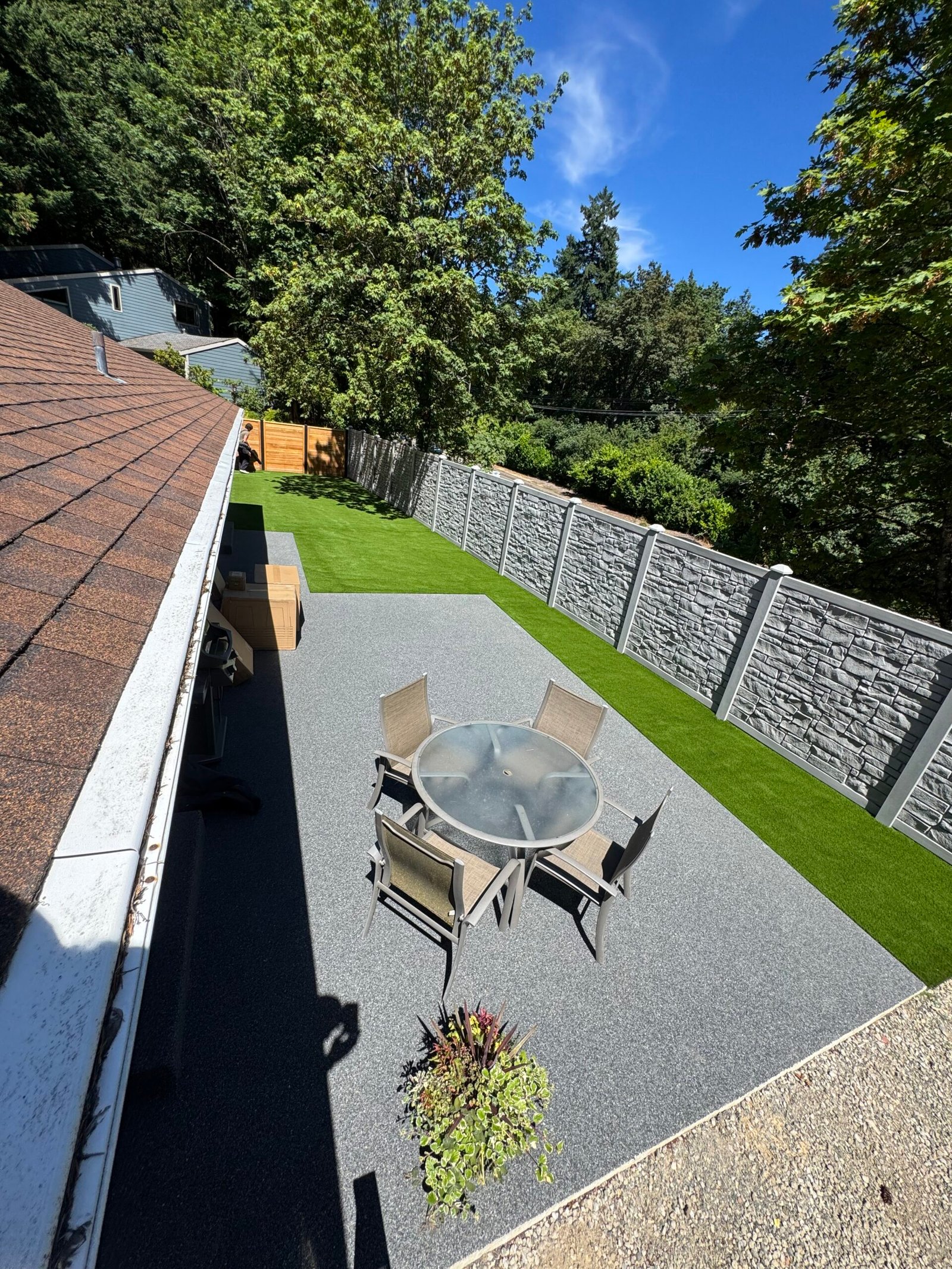 Patio and dining area framed by artificial turf